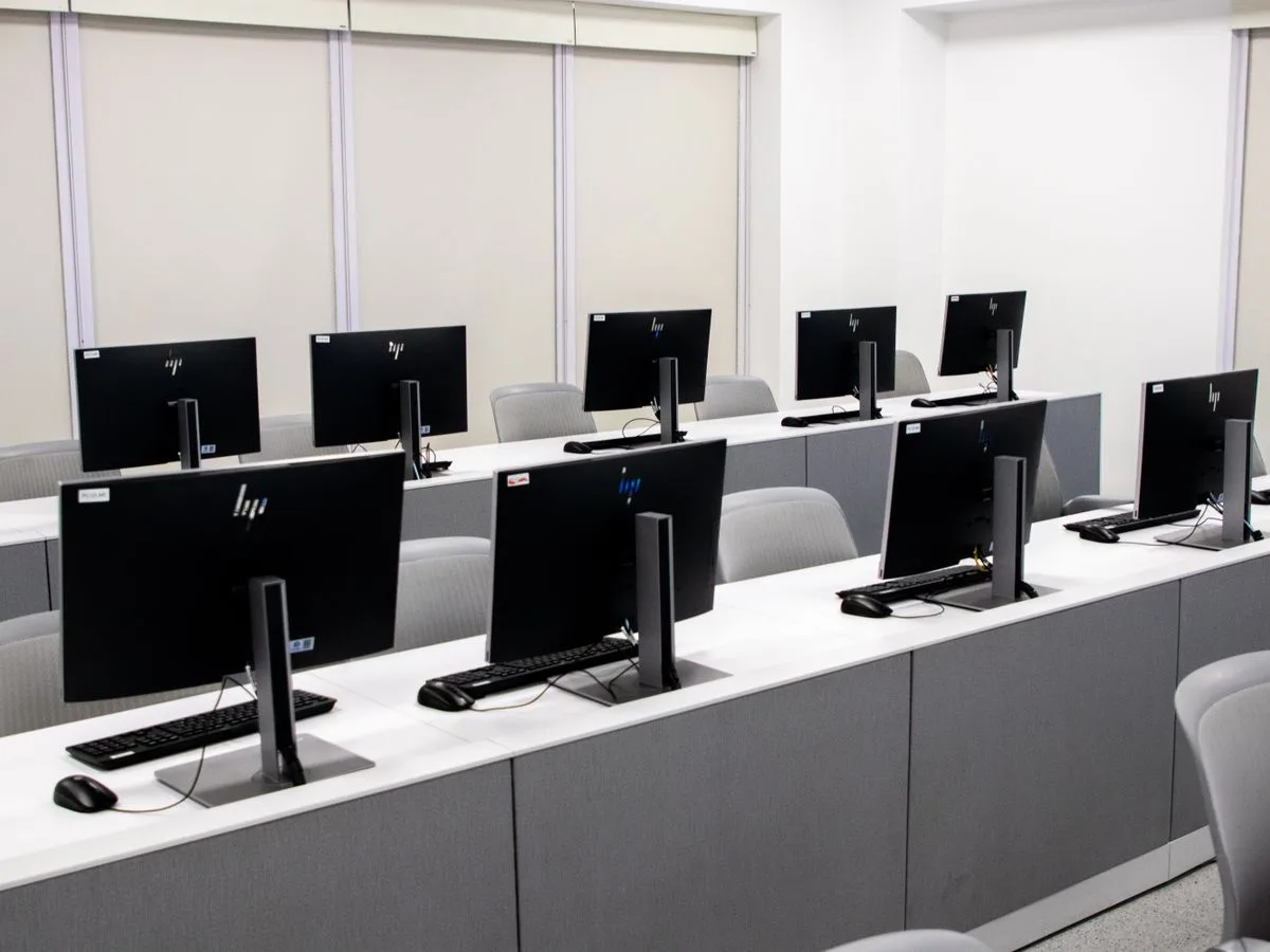 A modern school ICT computer lab with rows of desktop computers