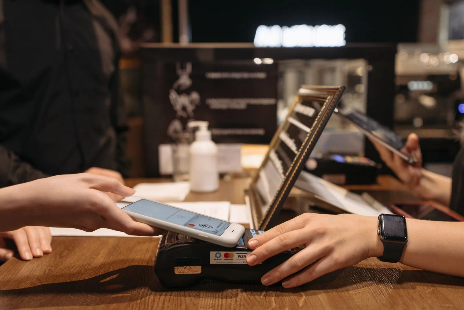 A parent making a contactless mobile payment with a smartphone